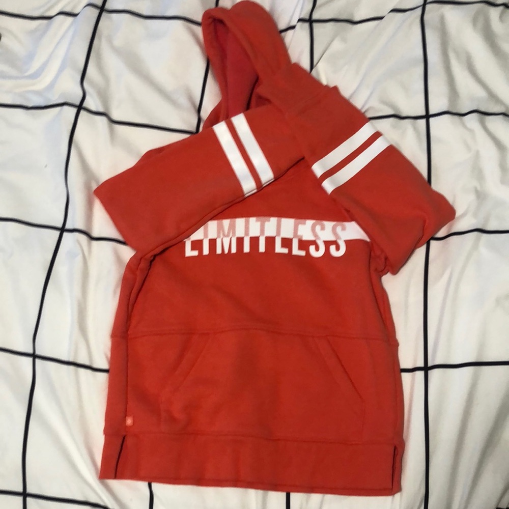 Orange Athleta Girl sweatshirt.